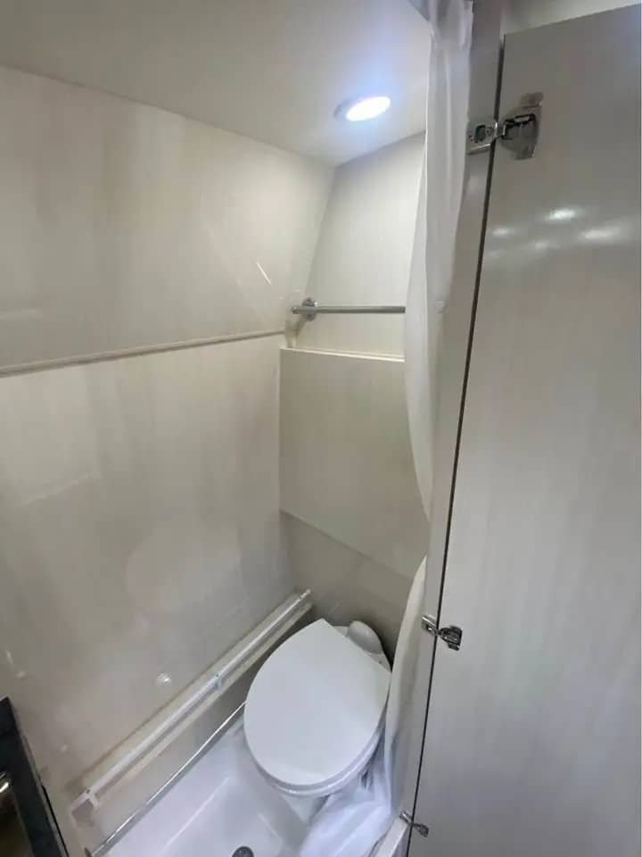 Sprinter 3500 camper bathroom with shower curtains