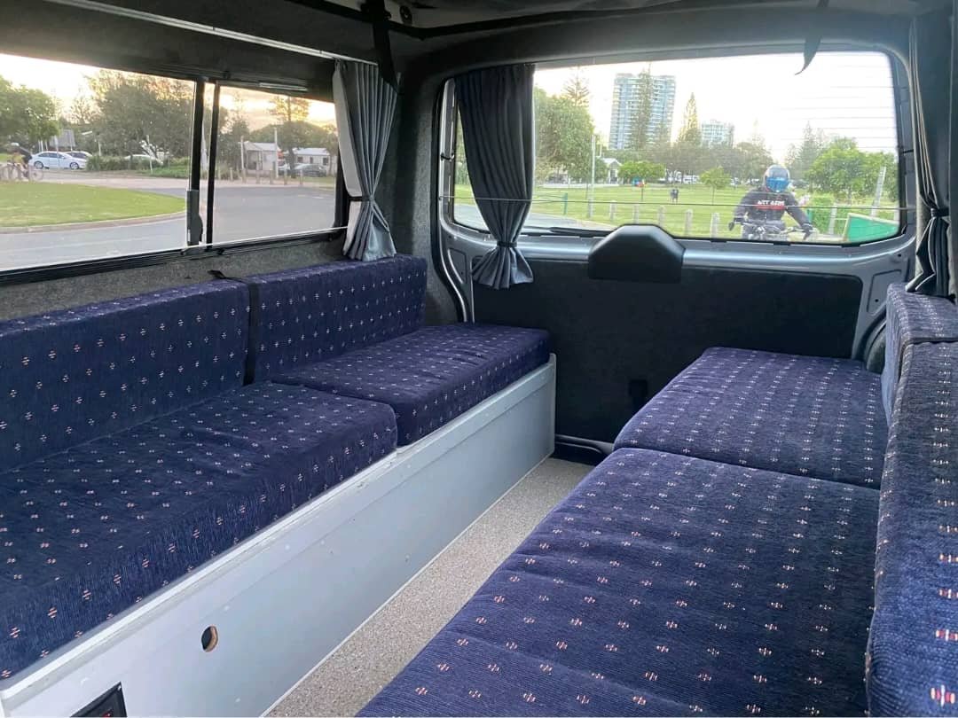 Bed conversion setup inside VW Transporter camper