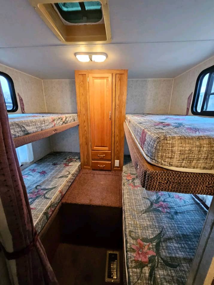 Dining area with table and seating in the 2002 Forest River Wildwood 32ft trailer.