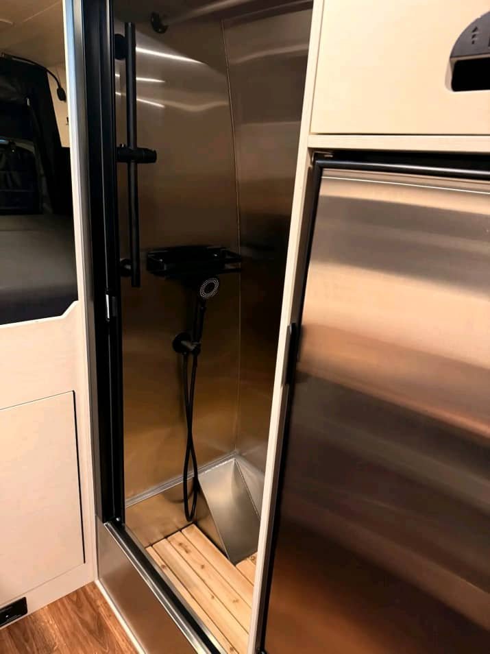 Built-in fridge freezer in Sprinter camper kitchen