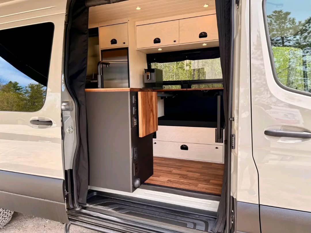 Indoor and outdoor cooking setup in custom Sprinter van