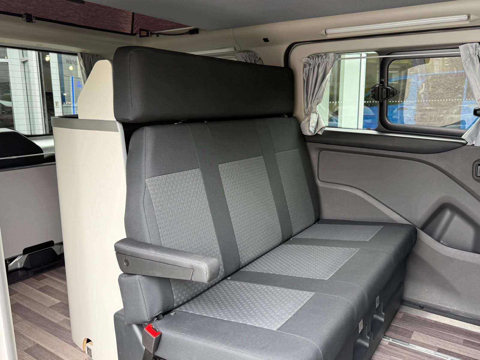 Lounge seating area inside the 2025 Next-Gen Nugget Pop-Top Campervan