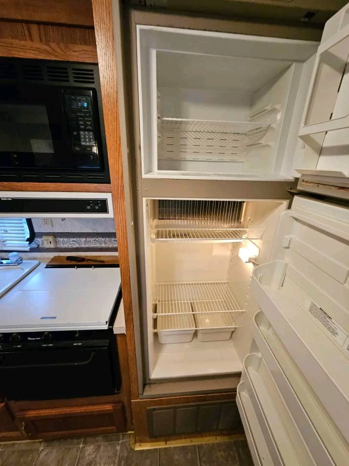 Full-size RV refrigerator inside the 2002 Wildwood kitchen.