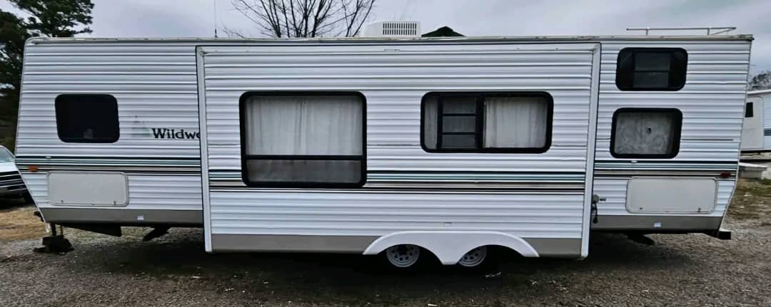 Side exterior view of the 2002 Wildwood 32ft bunkhouse travel trailer.