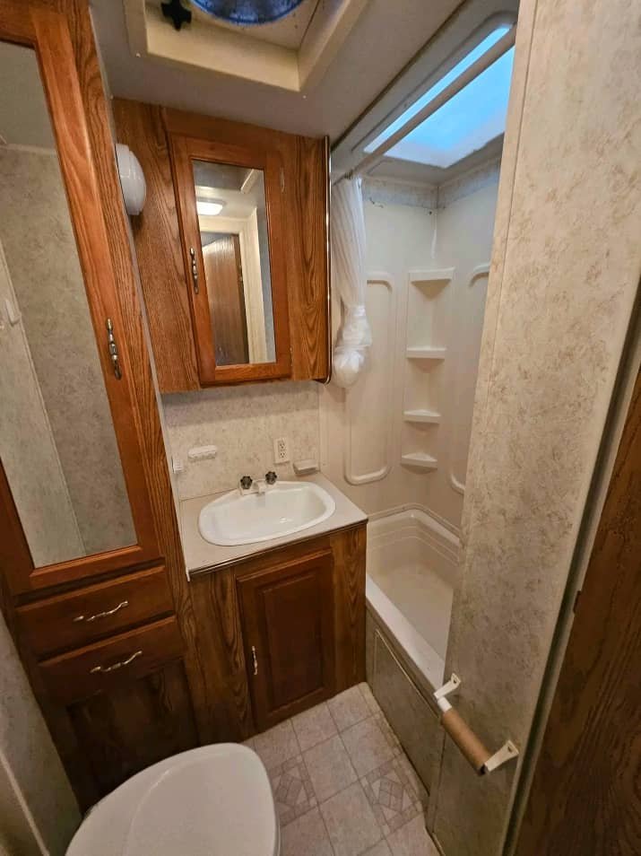 Kitchen sink and storage compartments in the Wildwood 32ft trailer.