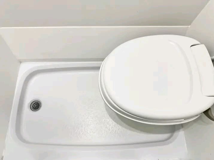 Flushing toilet in Transit campervan bathroom