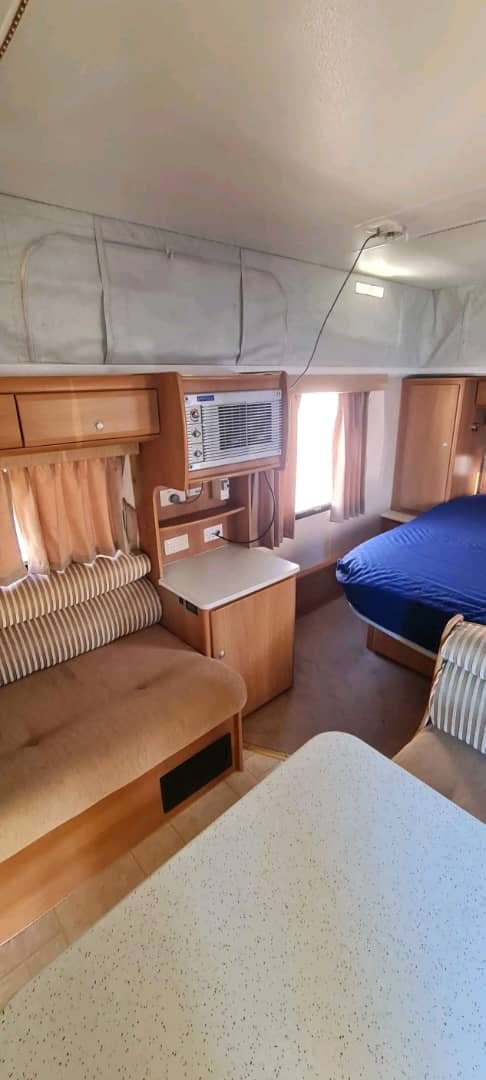 Main living area with dinette seating inside the Jayco J Series Poptop