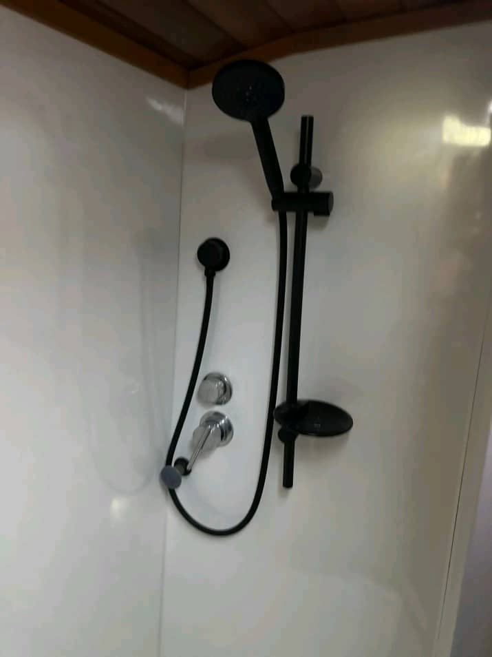 Indoor bathroom shower with hot and cold water in Mitsubishi Rosa motorhome