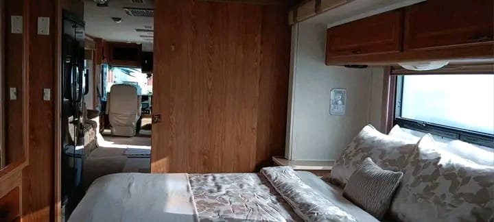 Bedroom with walk-around queen bed in Fleetwood Bounder motorhome