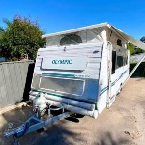 Front exterior view of Olympic Series 1000 pop-top caravan roof down camper van with solar panels