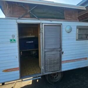 Front exterior of 1981 Millard Micro caravan with door open lightweight rv