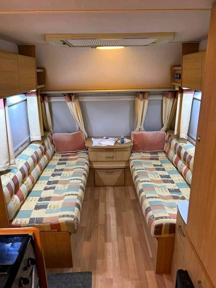 Lounge seating and dining area in Avondale Bianco 2005 caravan