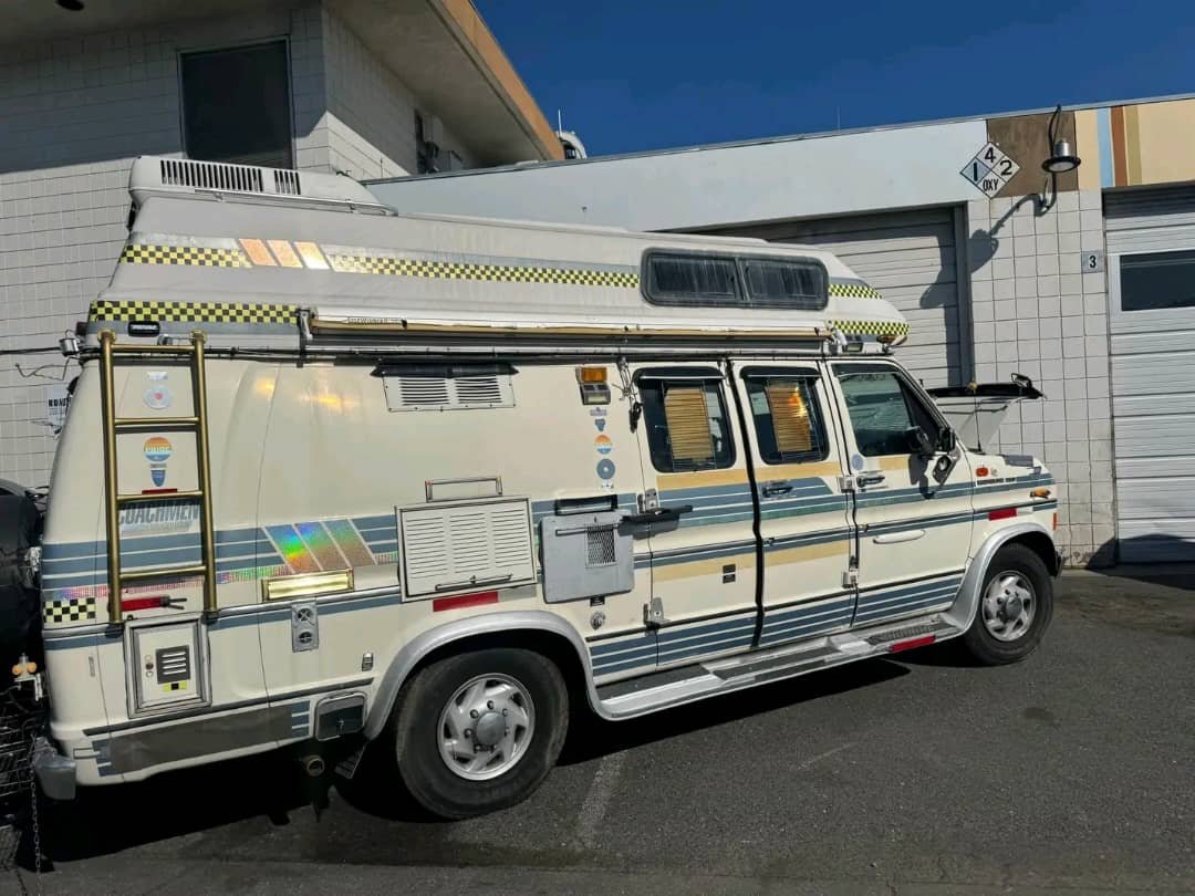 Side view with roof access steps on Econoline camper